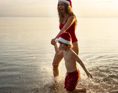 vignette-mother-son-beach-with-santa-hats.jpg